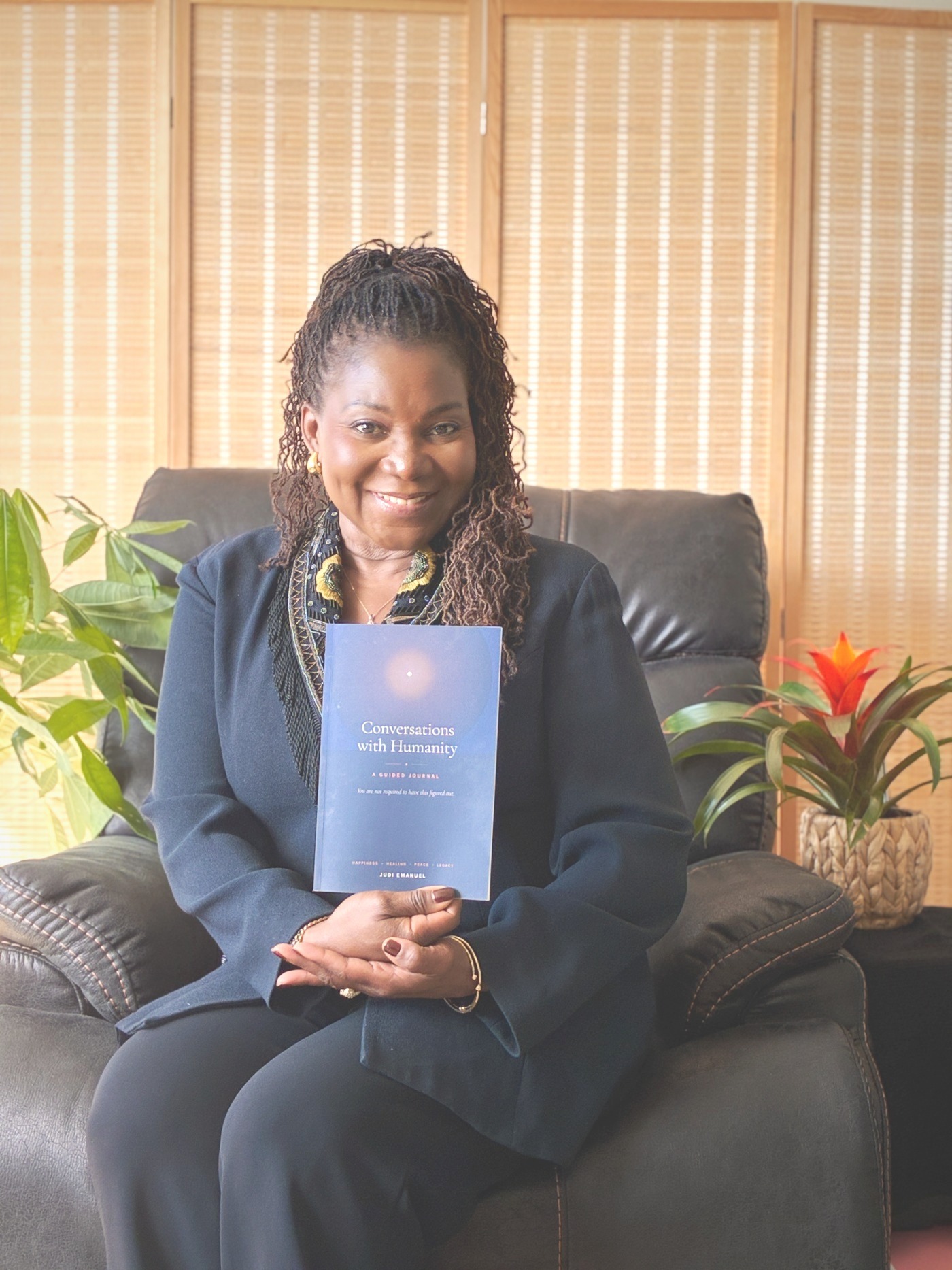 Judi Emanuel holding the journal